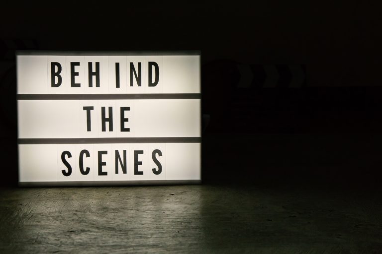 Street Marquee Displaying 'Behind the Scenes' in a Dark Setting